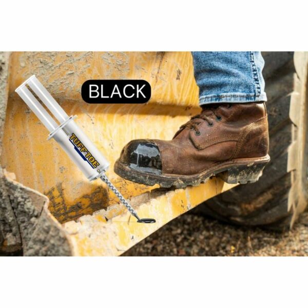Close-up of a rugged leather boot with black TUFF TOE protection stepping on a weathered yellow construction beam, complemented by a TUFF TOE adhesive tube showcasing the color 'BLACK'.